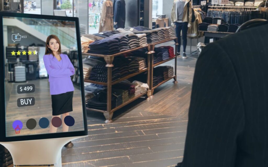 A customer interacts with a digital display showcasing a purple outfit priced at $499, surrounded by clothing racks in a store.