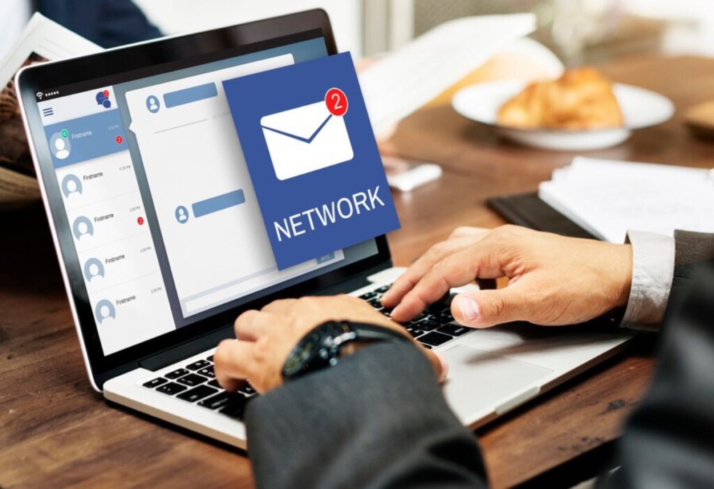 A person typing on a laptop, displaying a messaging interface with a notification for new network messages.
