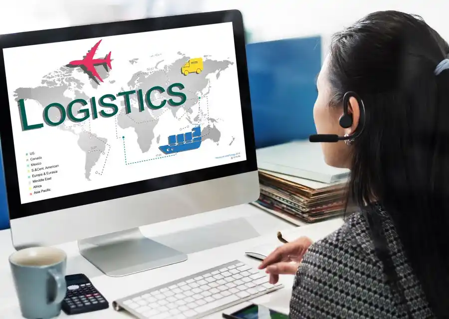 A woman with a headset analyzes a map showcasing global logistics, featuring transportation icons and the word Logistics prominently.